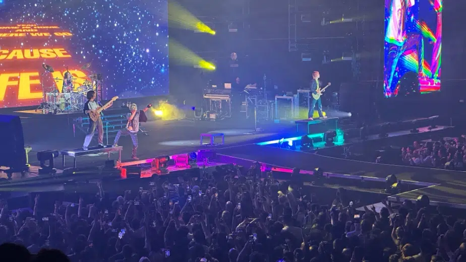 Full ONE OK ROCK band rocking out during the 2024 Premonition World Tour.